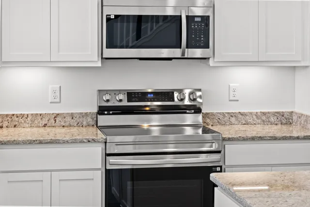 a stove top oven sitting inside of a kitchen