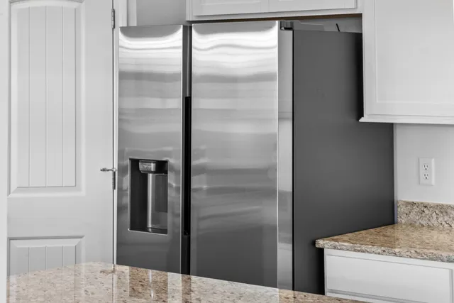 a kitchen with a refrigerator and cabinets