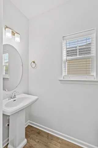 a bathroom with a sink a mirror and a toilet