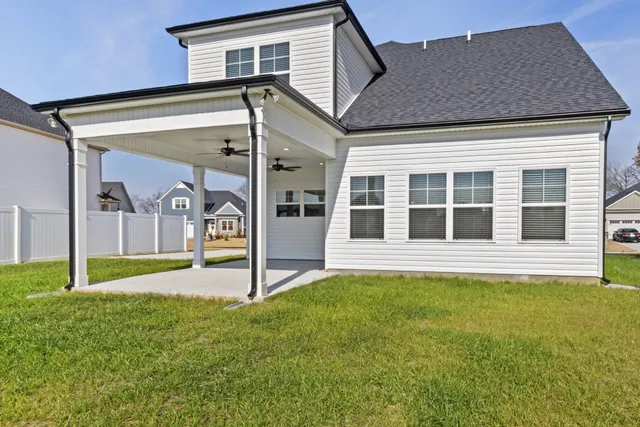 a view of a house with backyard and porch