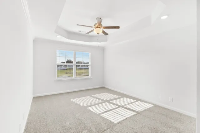 an empty room and chandelier fan