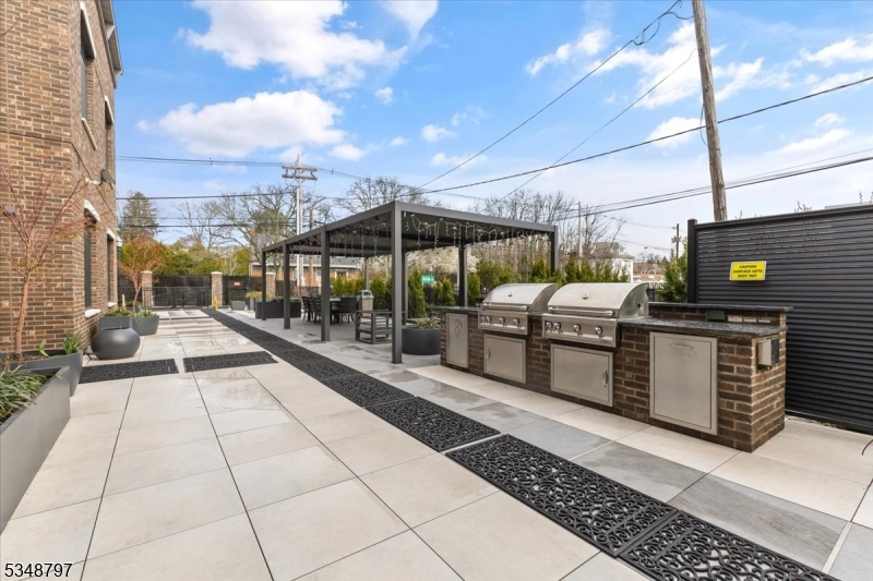 450 Springfield Avenue, Unit 301 Berkeley Heights, NJ 07922 - Photo 17 of 26 a view of a patio with a table and chairs