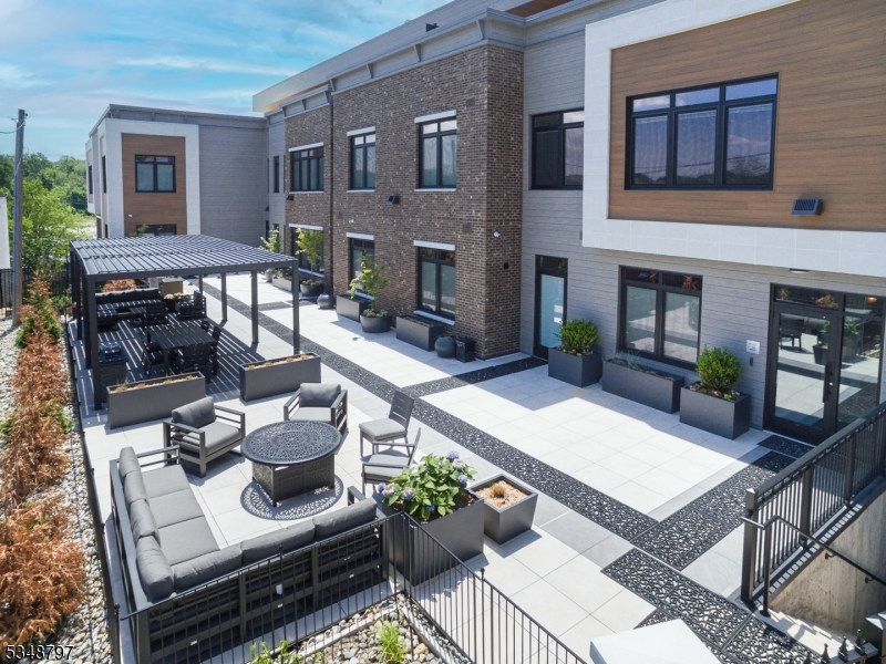 450 Springfield Avenue, Unit 301 Berkeley Heights, NJ 07922 - Photo 2 of 26 a view of a patio with couches table and chairs with potted plants