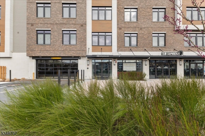 450 Springfield Avenue, Unit 301 Berkeley Heights, NJ 07922 - Photo 24 of 26 a front view of a residential apartment building with a yard