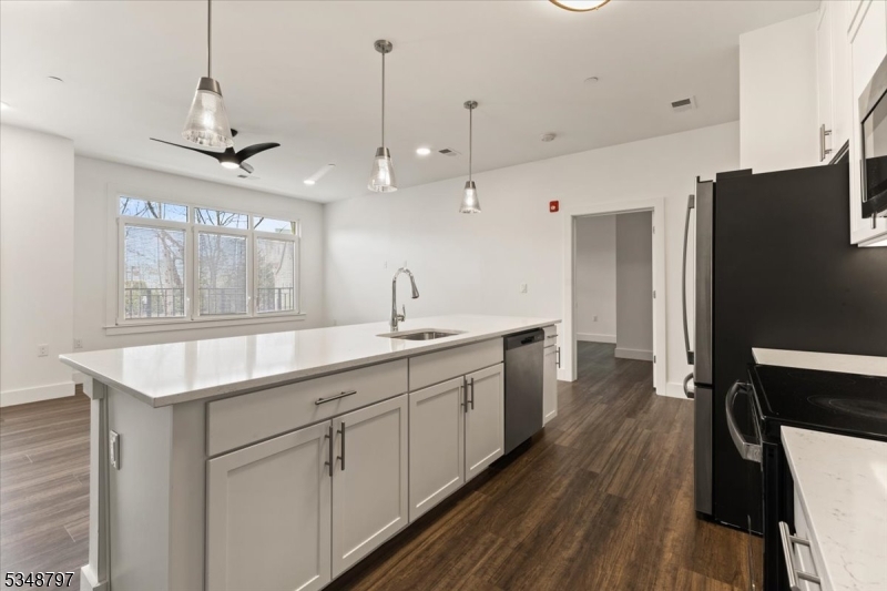 450 Springfield Avenue, Unit 301 Berkeley Heights, NJ 07922 - Photo 8 of 26 a large kitchen with a lot of counter space and wooden floor
