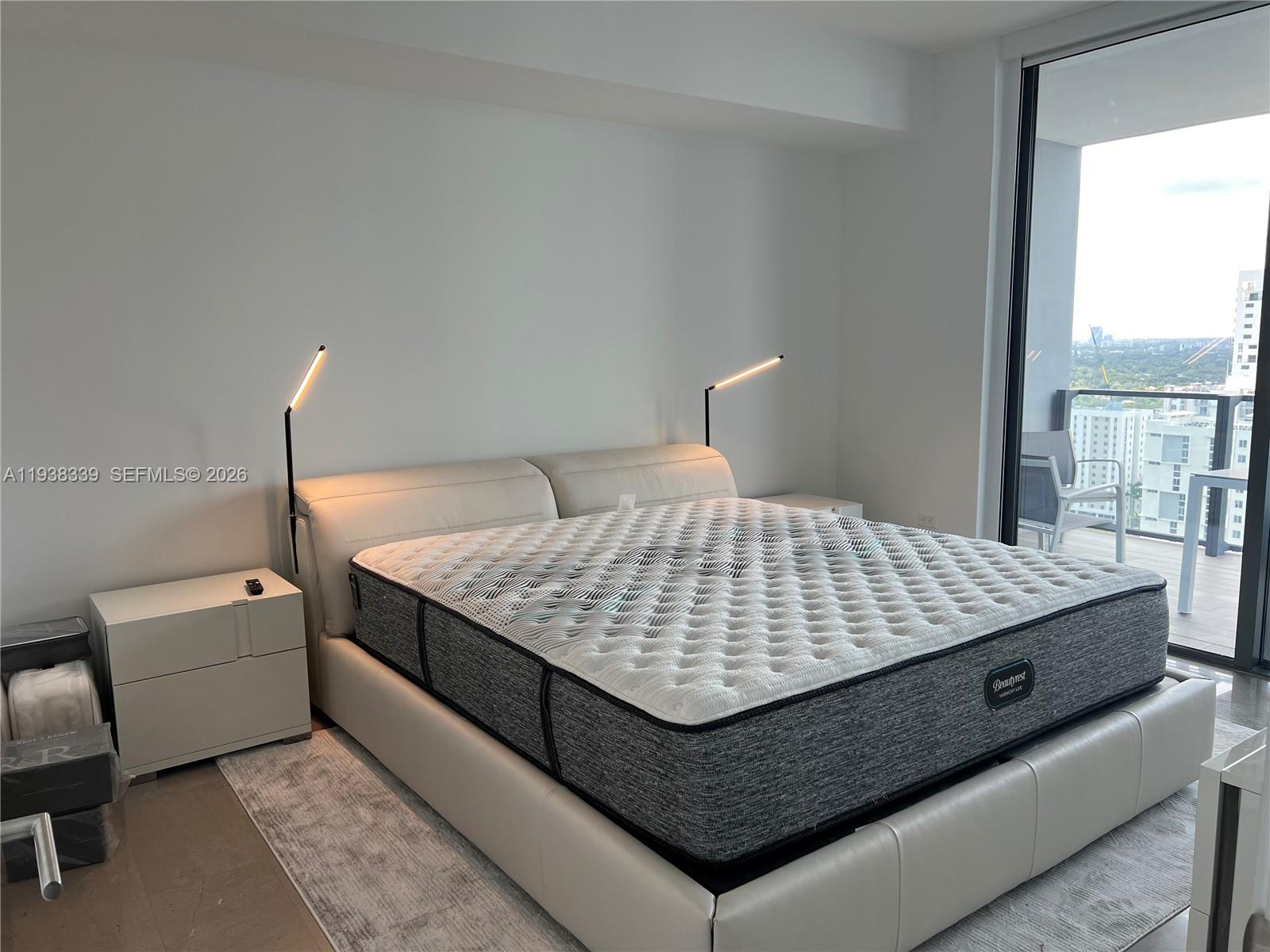 88 Southwest 7th Street, Unit 1706 Miami, FL 33130 - Photo 6 of 14 a bedroom with a bed and window