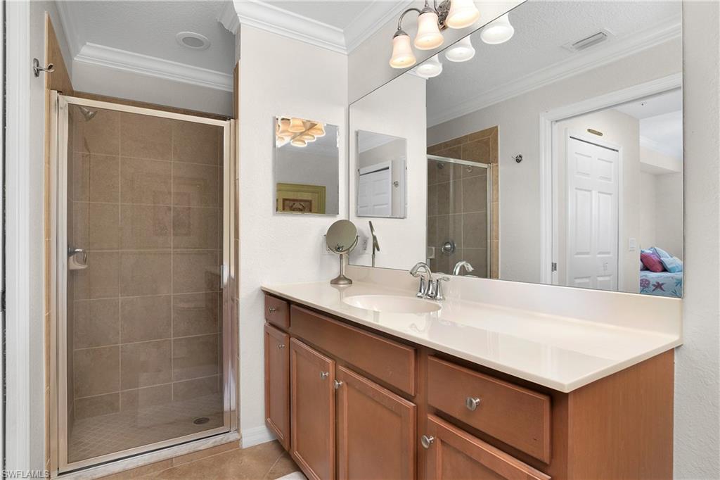 9719 Acqua Court, Unit 214 Naples, FL 34113 - Photo 19 of 50 a bathroom with a sink vanity granite and a mirror