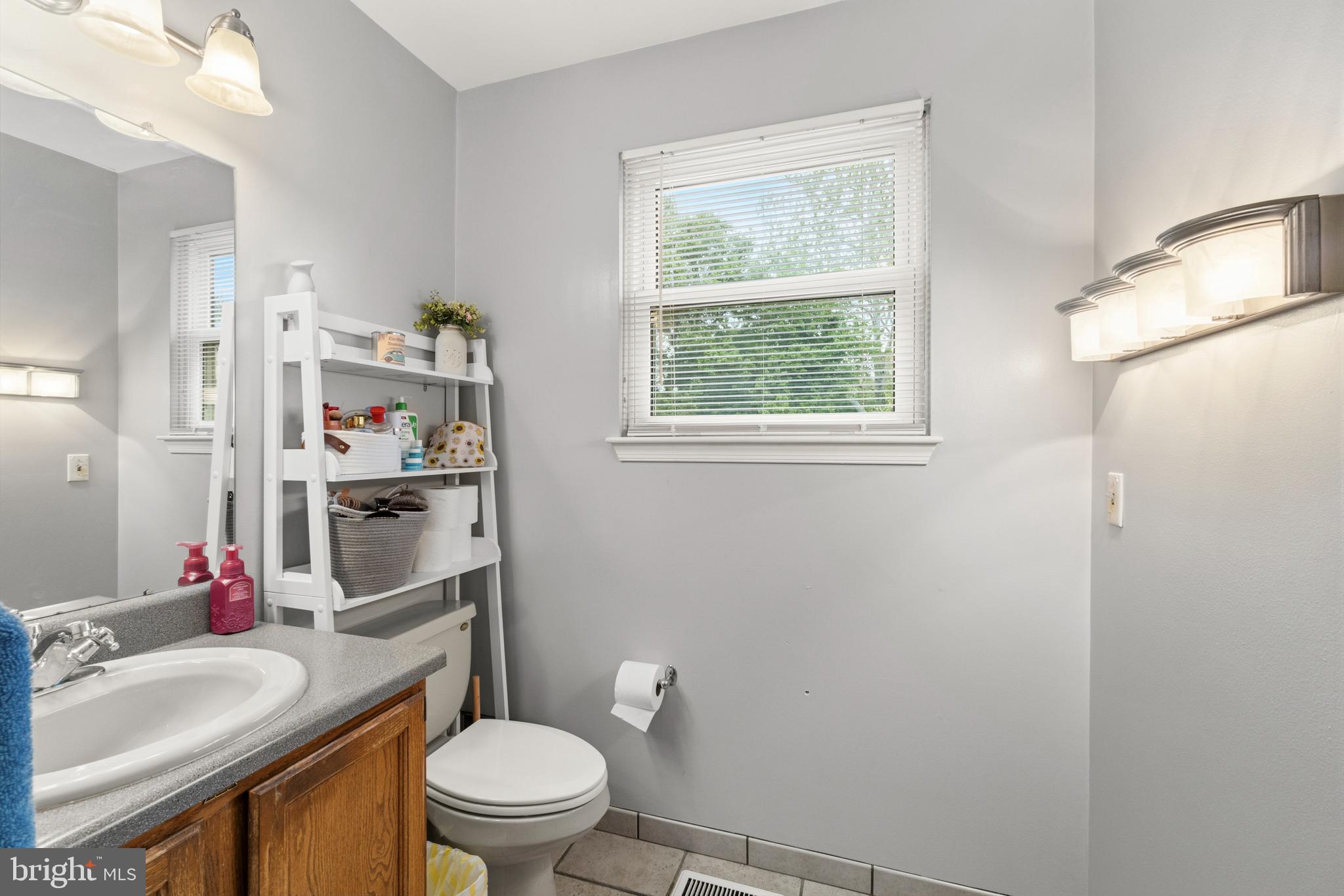 2 Farnham Court Laurel Springs, NJ 08021 - Photo 15 of 33 a bathroom with a sink toilet vanity and window