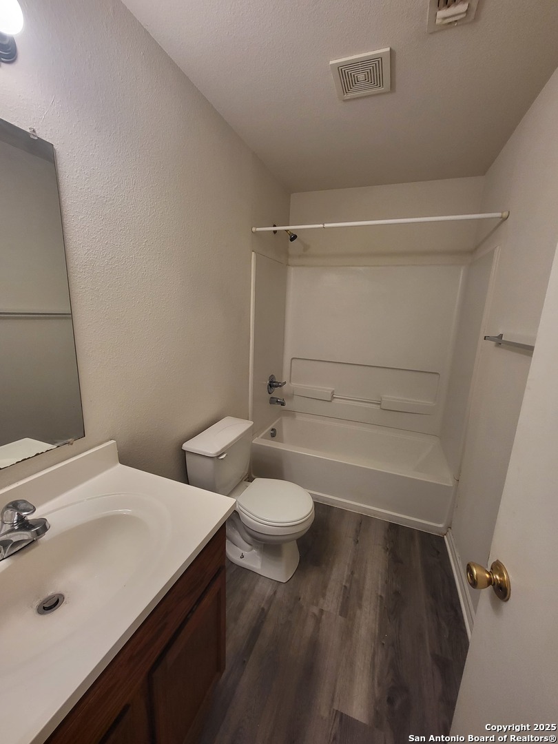 10006 Vasso View, Unit 4 Converse, TX 78109 - Photo 11 of 15 a bathroom with a sink a toilet and shower