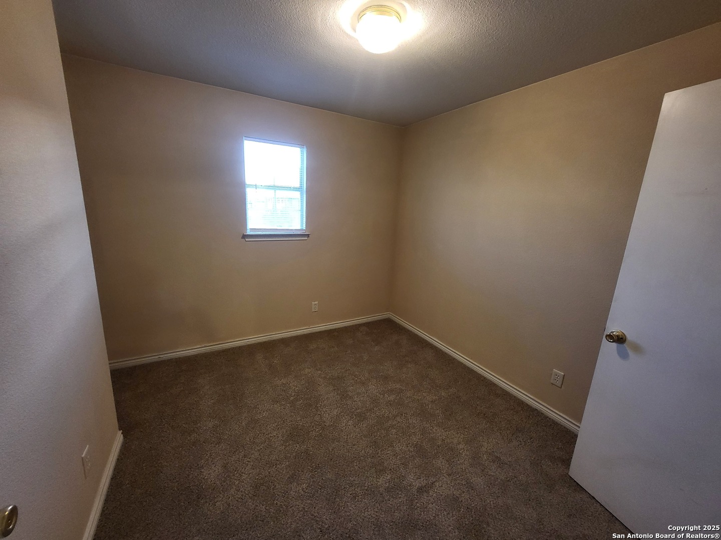 10006 Vasso View, Unit 4 Converse, TX 78109 - Photo 9 of 15 an empty room with a window