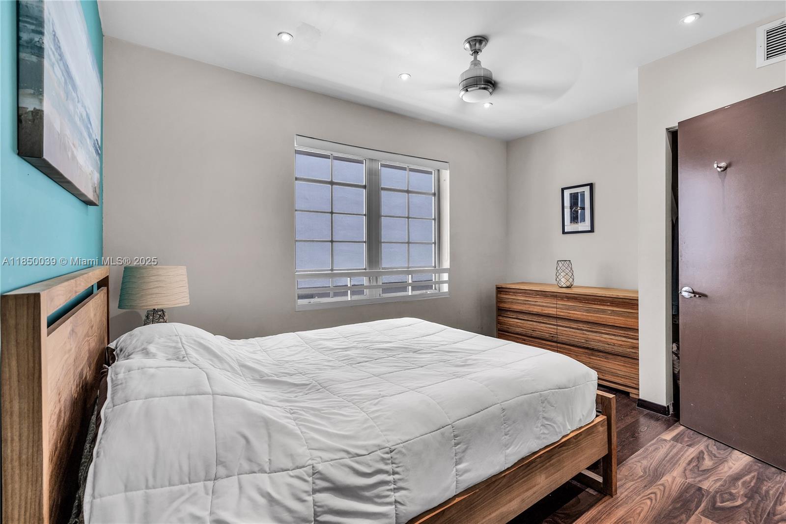 435 21st Street, Unit 322 Miami Beach, FL 33139 - Photo 11 of 41 a bedroom with a bed and a chandelier