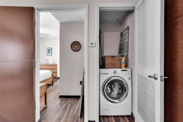 a view of a hallway with washer and dryer