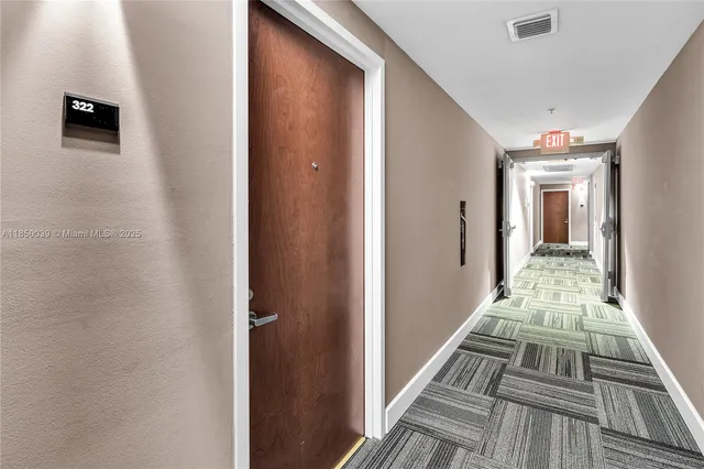 a view of a hallway with a dining room and stairs