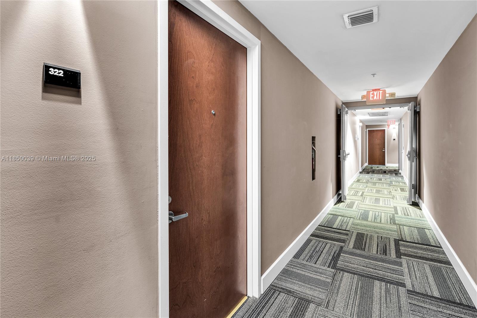 435 21st Street, Unit 322 Miami Beach, FL 33139 - Photo 14 of 41 a view of a hallway with a dining room and stairs