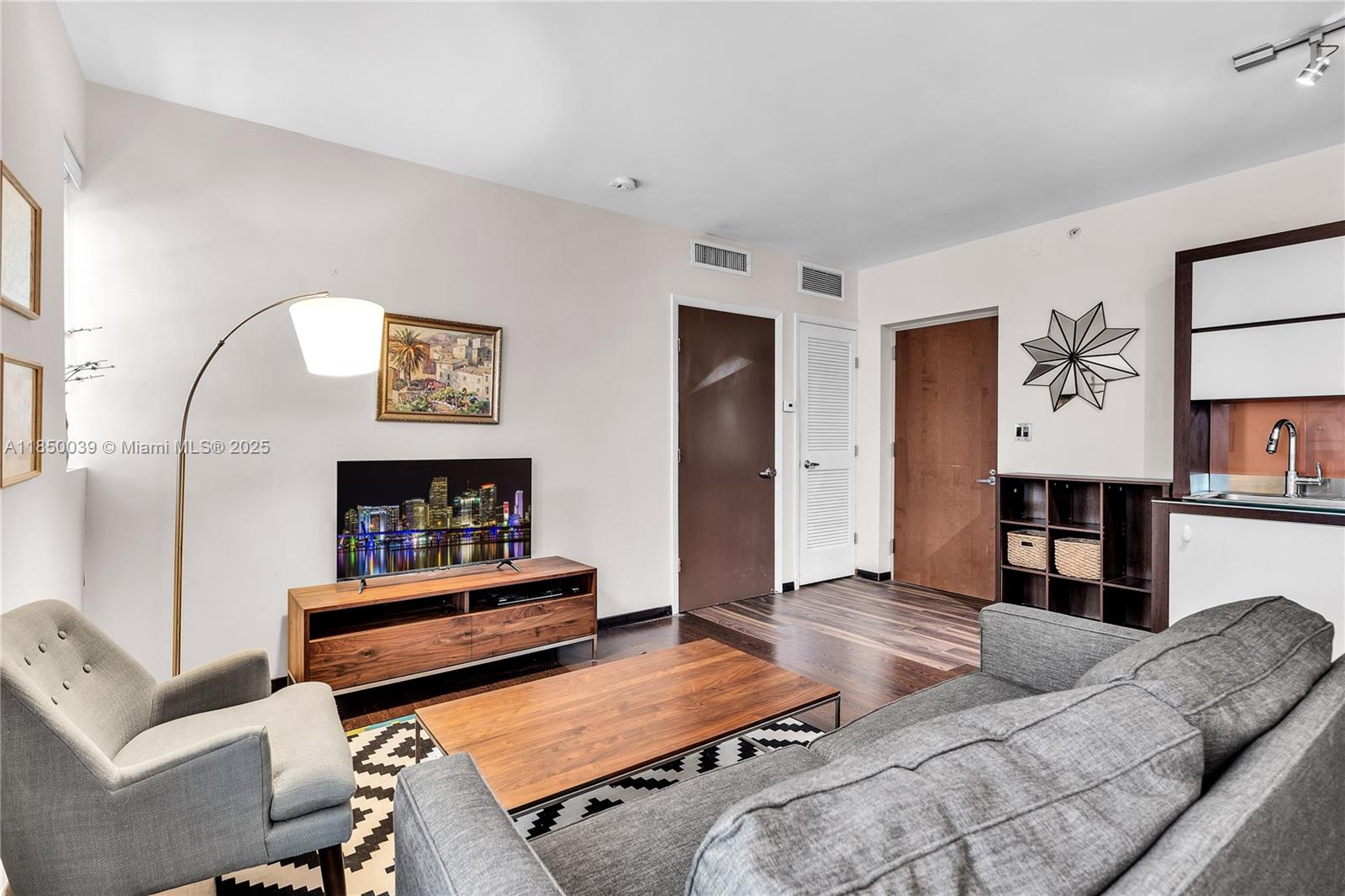 435 21st Street, Unit 322 Miami Beach, FL 33139 - Photo 3 of 41 a living room with furniture and wooden floor