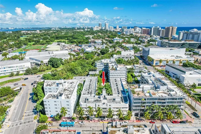a city view with large buildings and cars parked