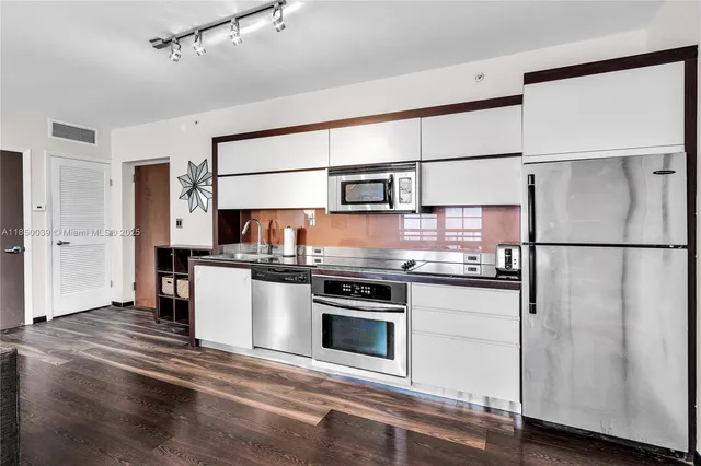 a kitchen with stainless steel appliances granite countertop a stove and a refrigerator