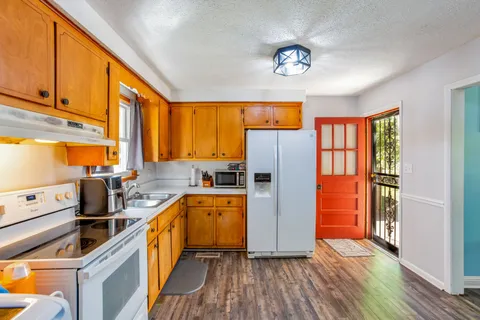 a kitchen with stainless steel appliances a refrigerator sink and cabinets