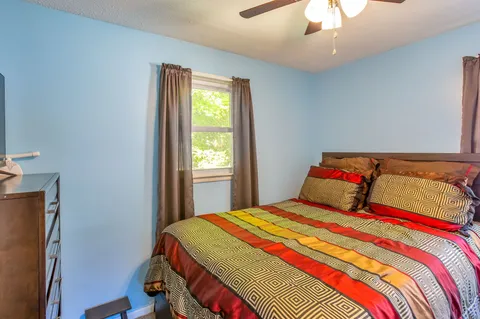 a bedroom with a bed and a window