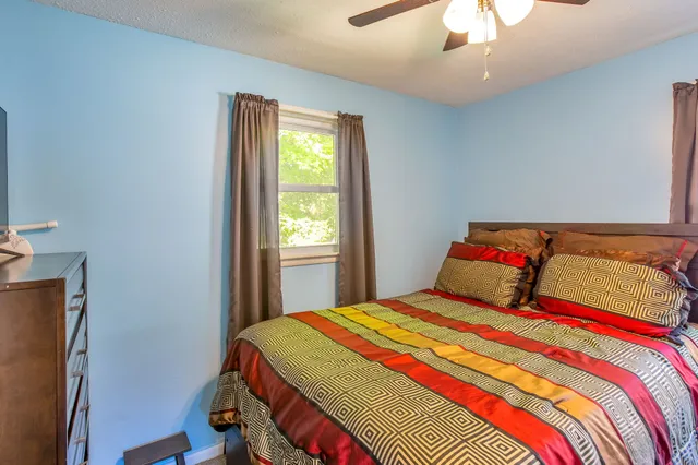 a bedroom with a bed and a window