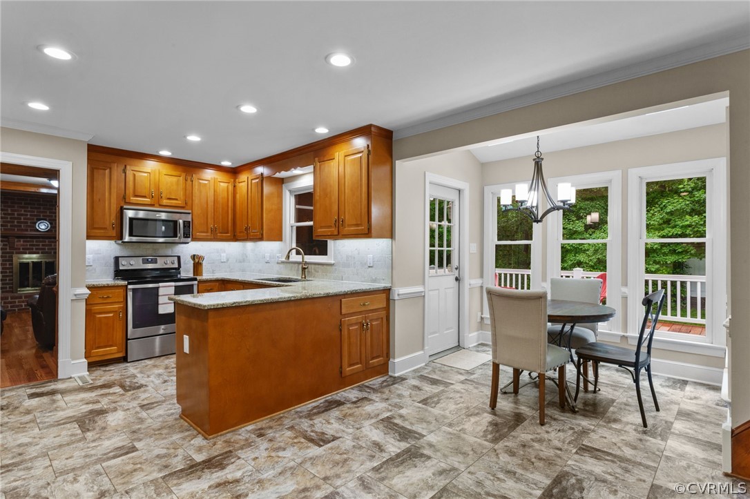 413 Lancey Drive Midlothian, VA 23114 - Photo 13 of 46 a kitchen with stainless steel appliances granite countertop a stove top oven a sink a dining table and chairs