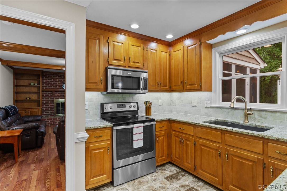 413 Lancey Drive Midlothian, VA 23114 - Photo 15 of 46 a kitchen with stainless steel appliances granite countertop a stove a sink and a microwave