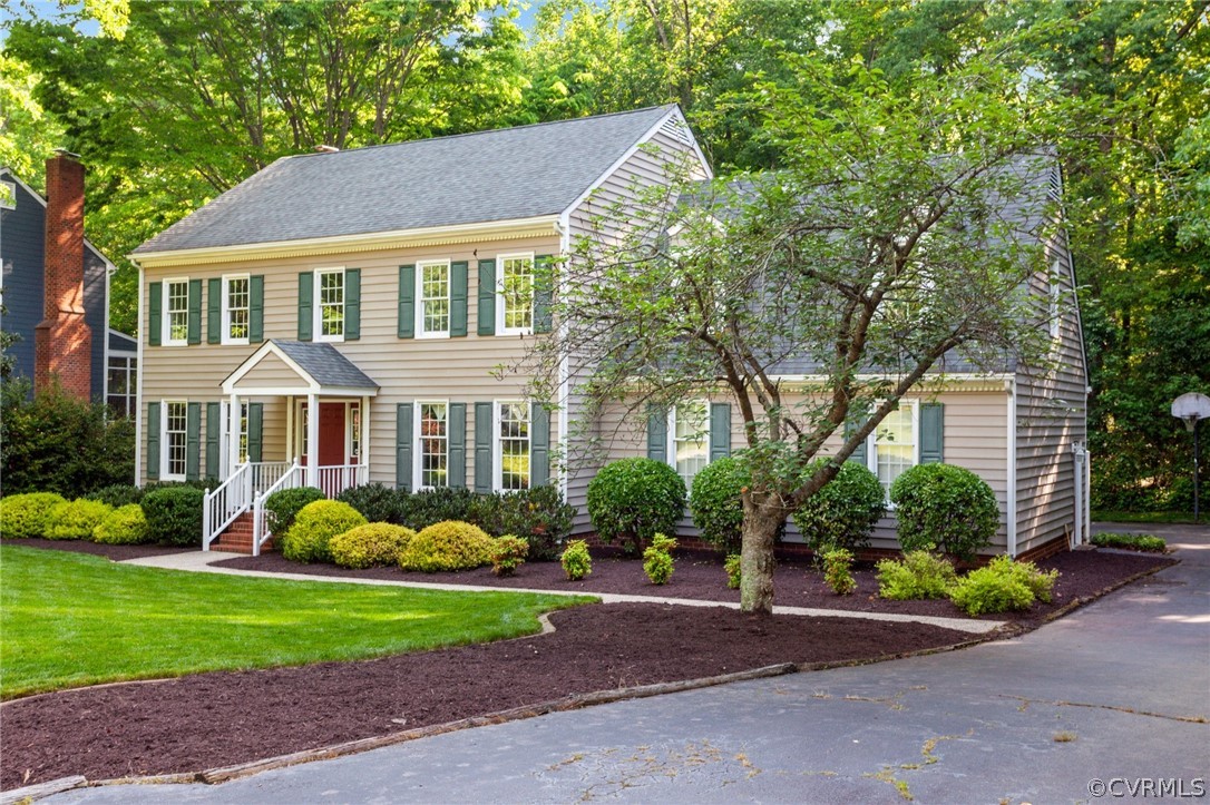 413 Lancey Drive Midlothian, VA 23114 - Photo 3 of 46 a front view of a house with garden and trees