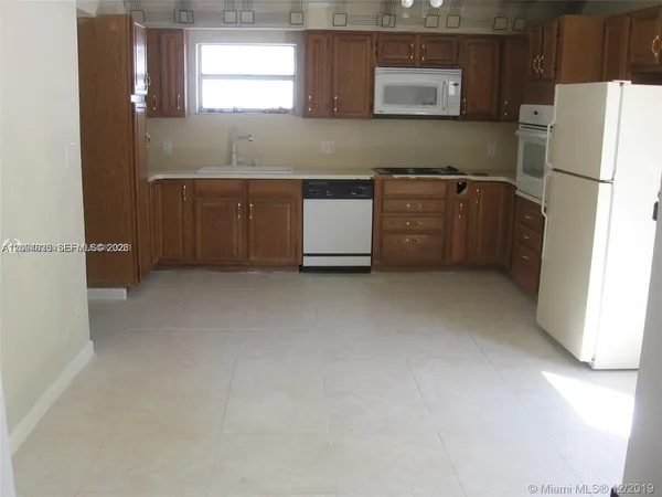 a kitchen with stainless steel appliances a refrigerator and a sink