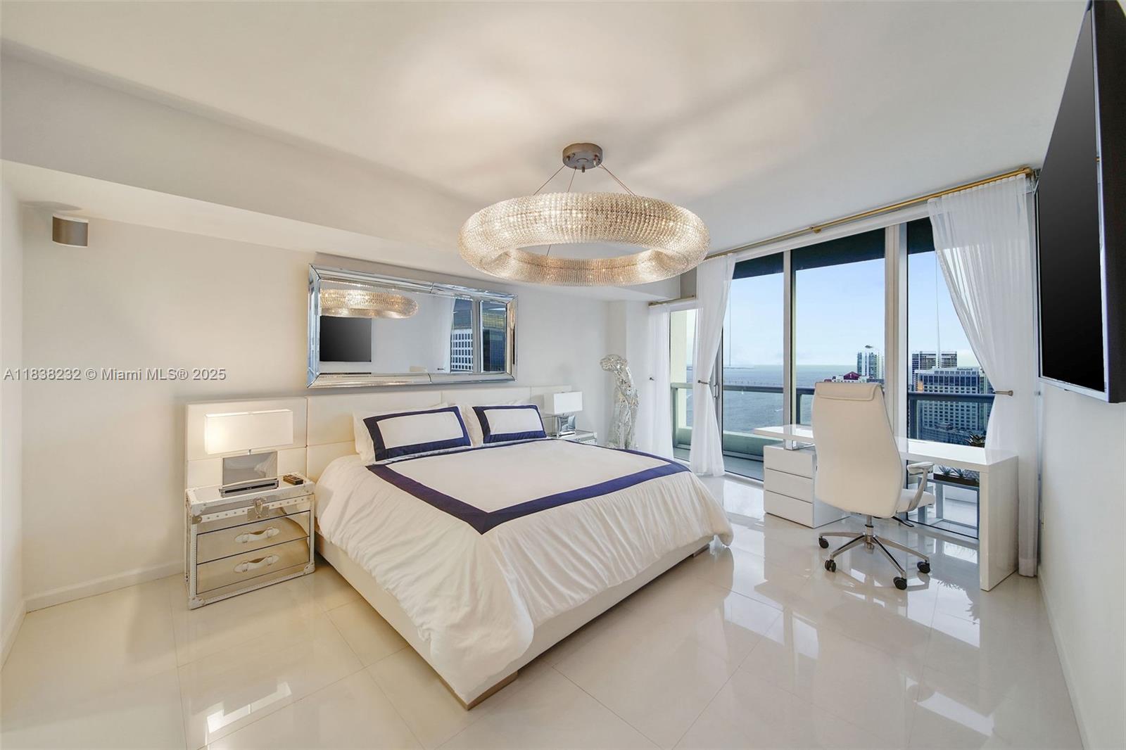 495 Brickell Avenue, Unit 4209 Miami, FL 33131 - Photo 17 of 37 a bedroom with a bed and a chandelier