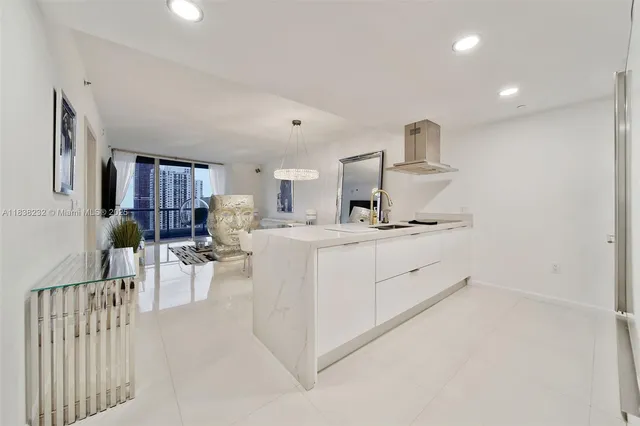 a kitchen with stainless steel appliances a sink stove and refrigerator