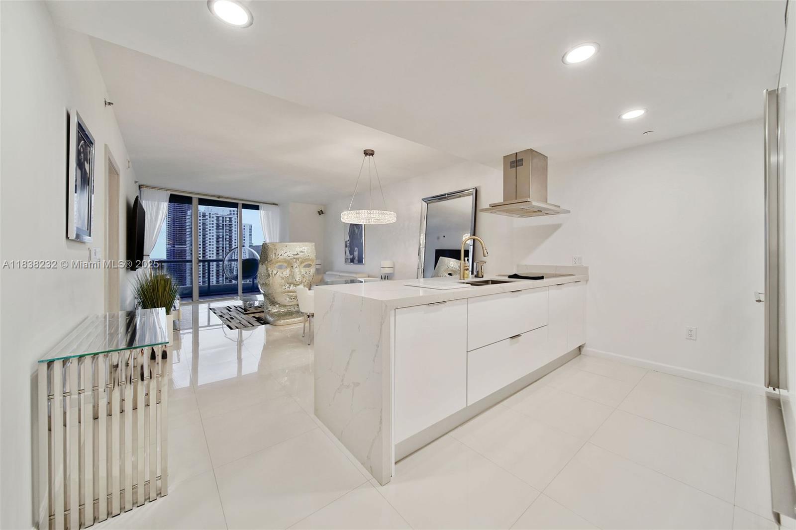 495 Brickell Avenue, Unit 4209 Miami, FL 33131 - Photo 2 of 37 a room with white cabinets and couches with wooden floor