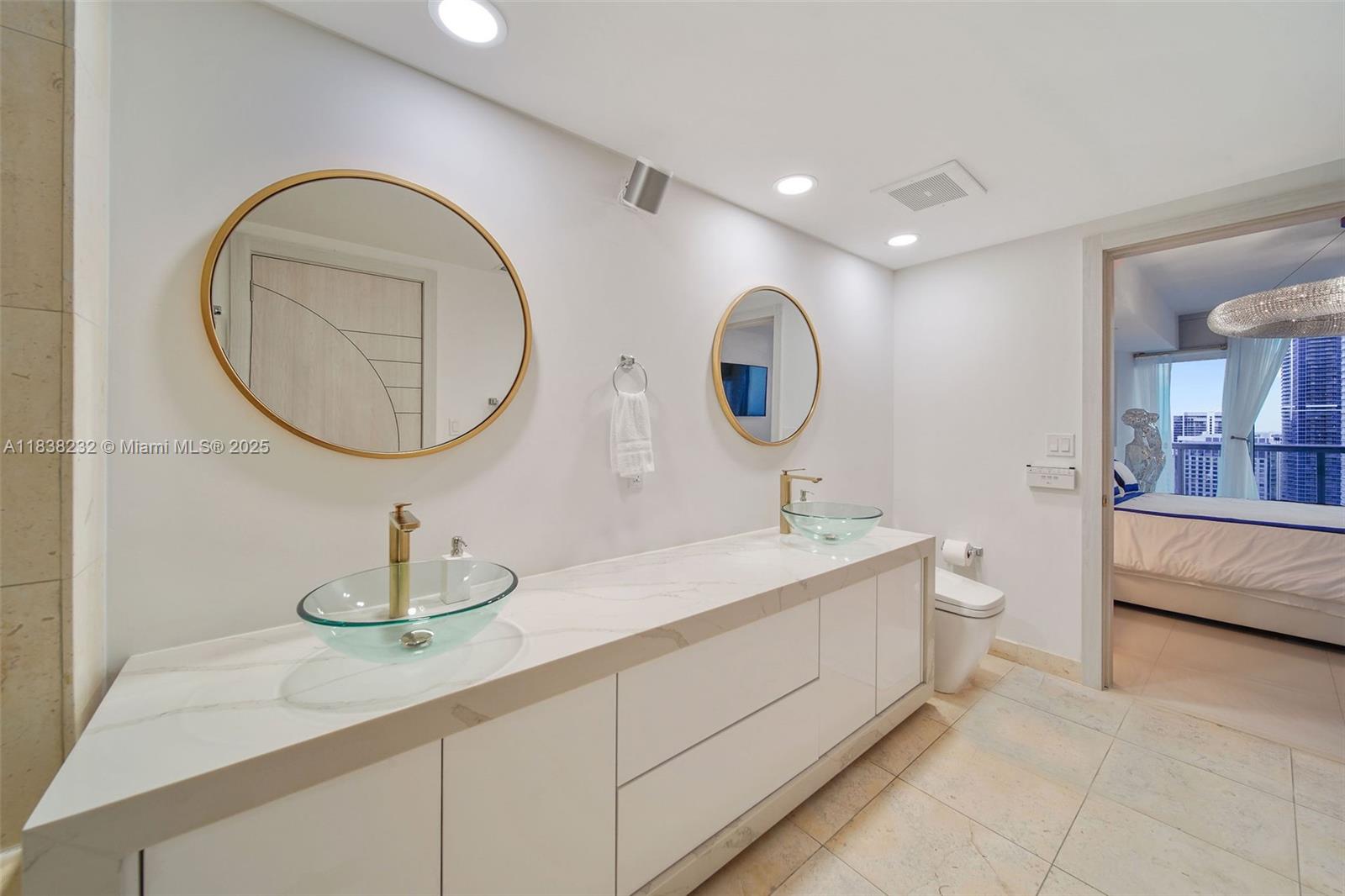 495 Brickell Avenue, Unit 4209 Miami, FL 33131 - Photo 23 of 37 a bathroom with a double vanity sink and a mirror