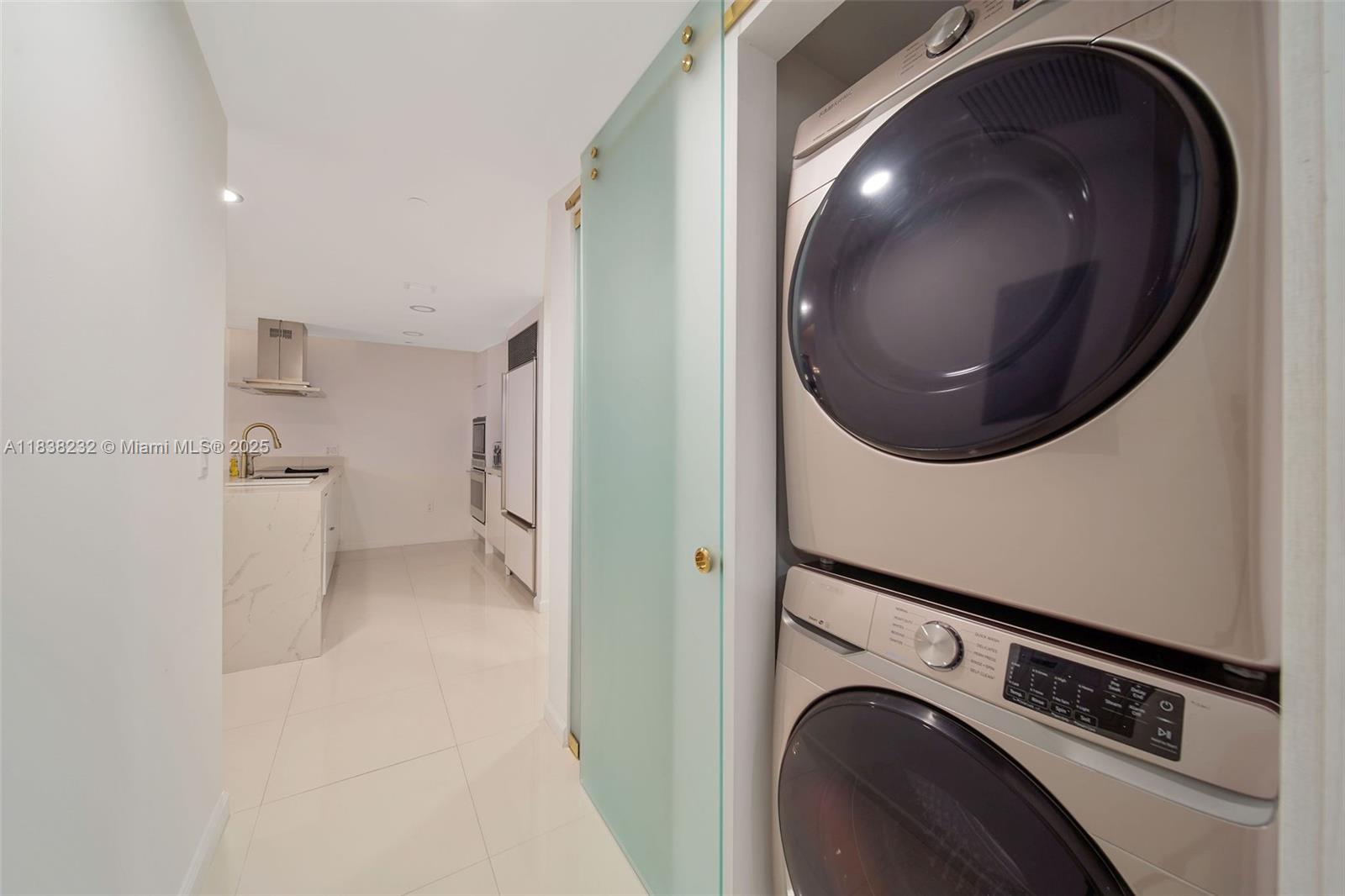 495 Brickell Avenue, Unit 4209 Miami, FL 33131 - Photo 25 of 37 a view of a storage and utility room with a washer and dryer
