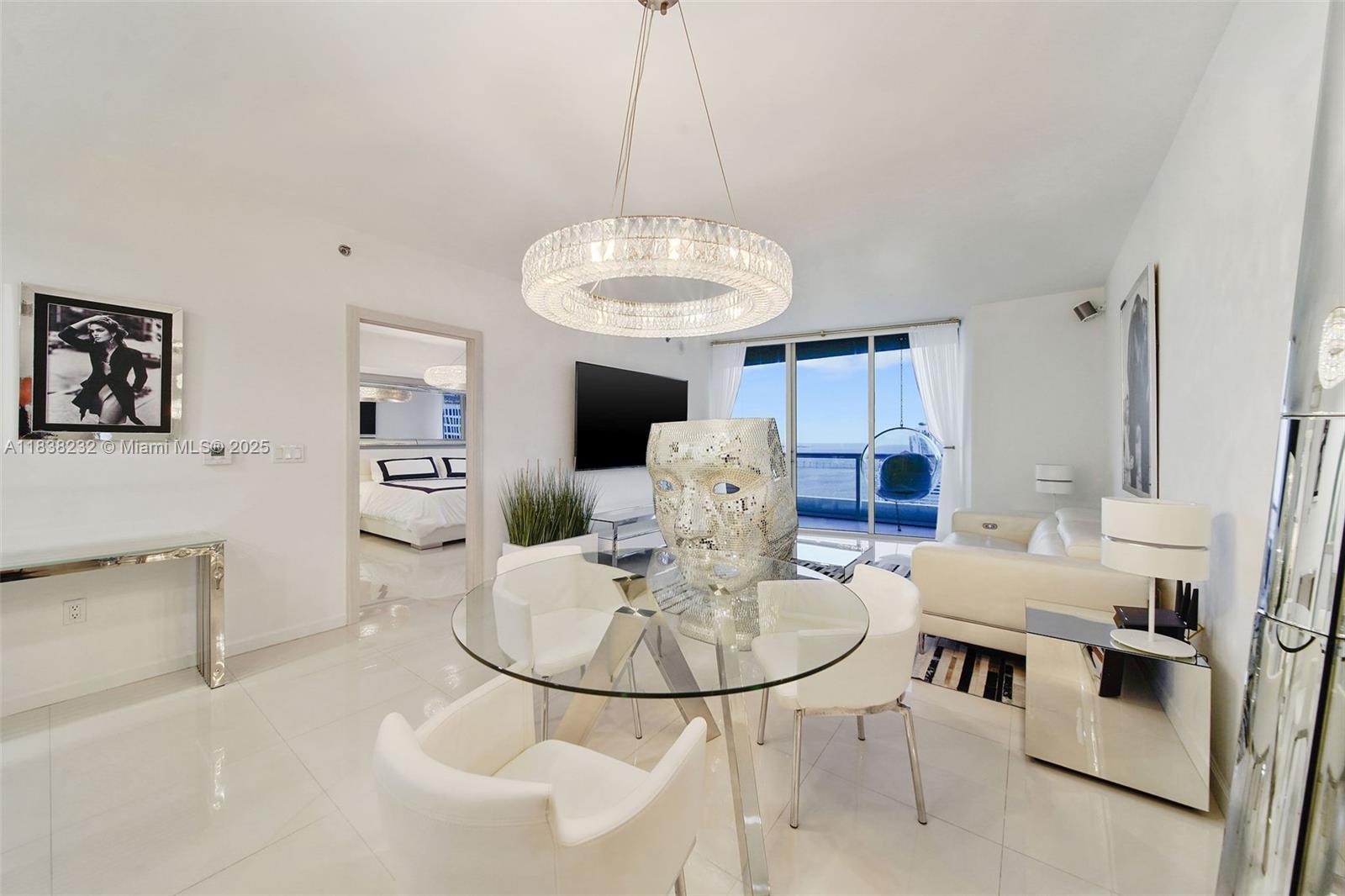 495 Brickell Avenue, Unit 4209 Miami, FL 33131 - Photo 6 of 37 a living room with stainless steel appliances furniture a dining table and a chandelier