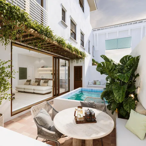 a dining room with furniture and a potted plant