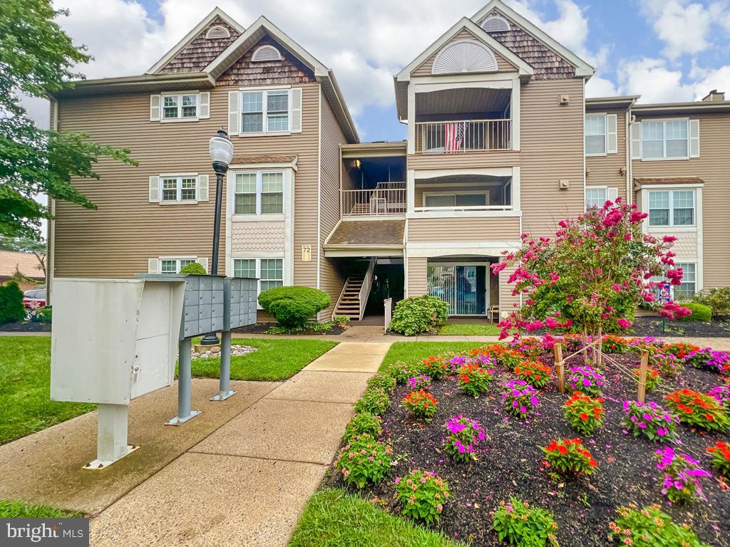 72203 Delaire Landing Road, Unit 203 Philadelphia, PA 19114 - Photo 3 of 32 front view of house that has a lot of flowers in it