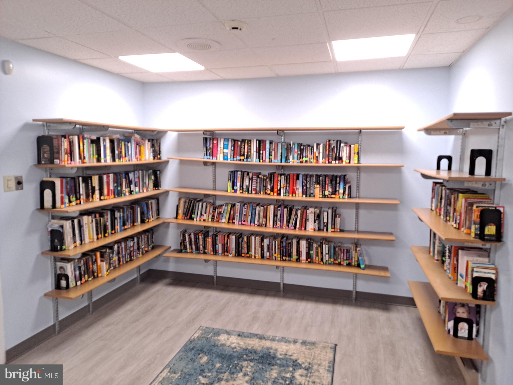 72203 Delaire Landing Road, Unit 203 Philadelphia, PA 19114 - Photo 31 of 32 a living room with a book shelf and a book shelf