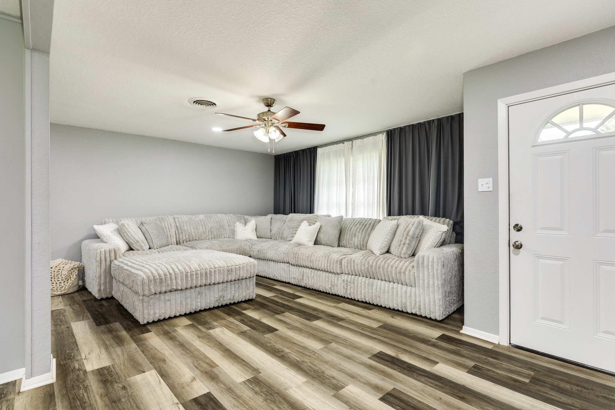 908 West Mulberry Street Angleton, TX 77515 - Photo 5 of 22 a living room with furniture and a chandelier
