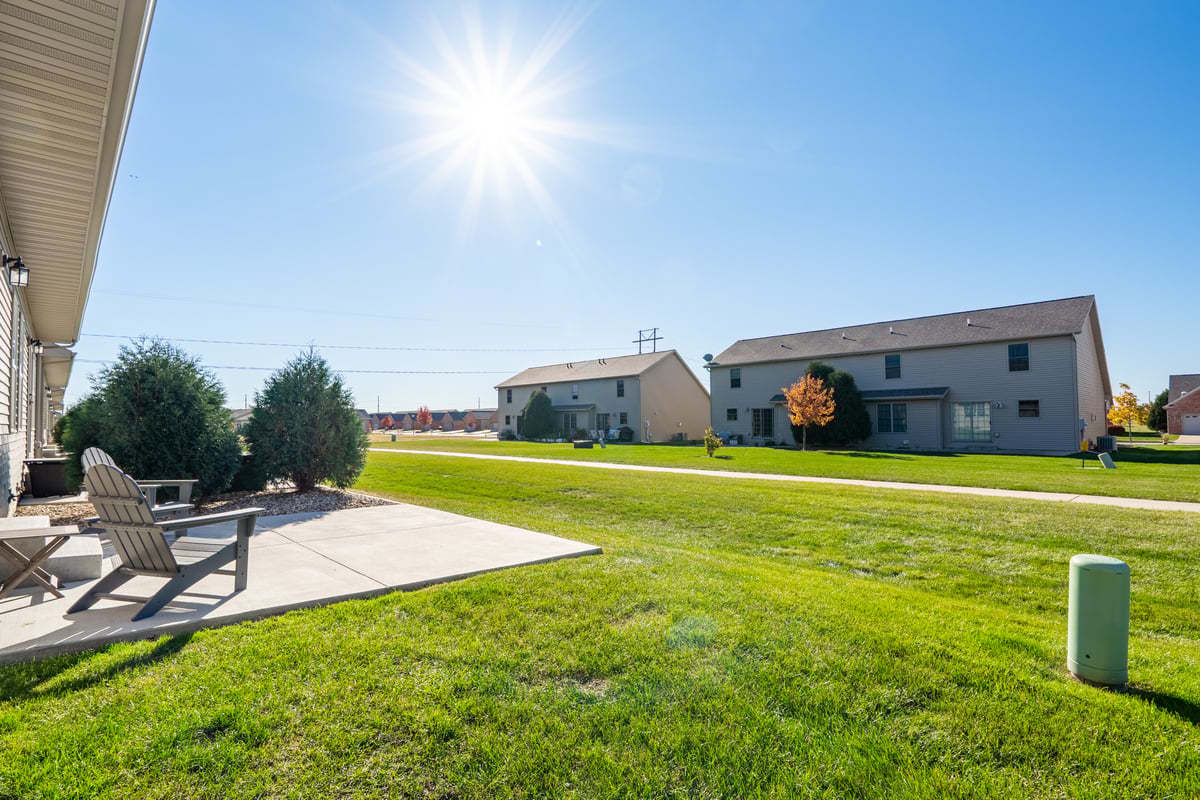 1809 Glenbridge Road Bloomington, IL 61704 - Photo 18 of 23 a view of a swimming pool with lawn chairs with plants and palm trees