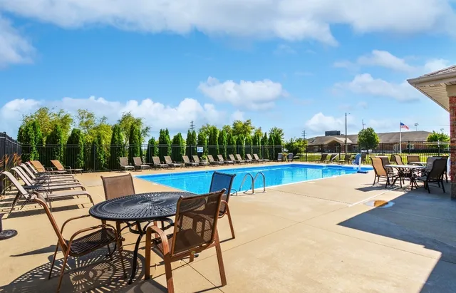 a view of a patio with a table and chairs
