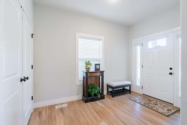 a hallway with a wooden floor and a table