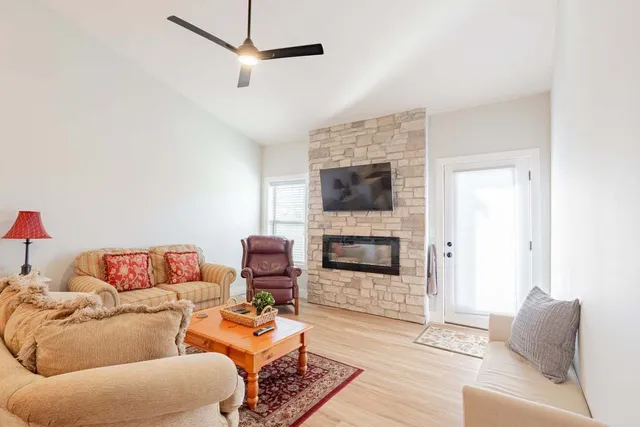 a living room with furniture and a fireplace