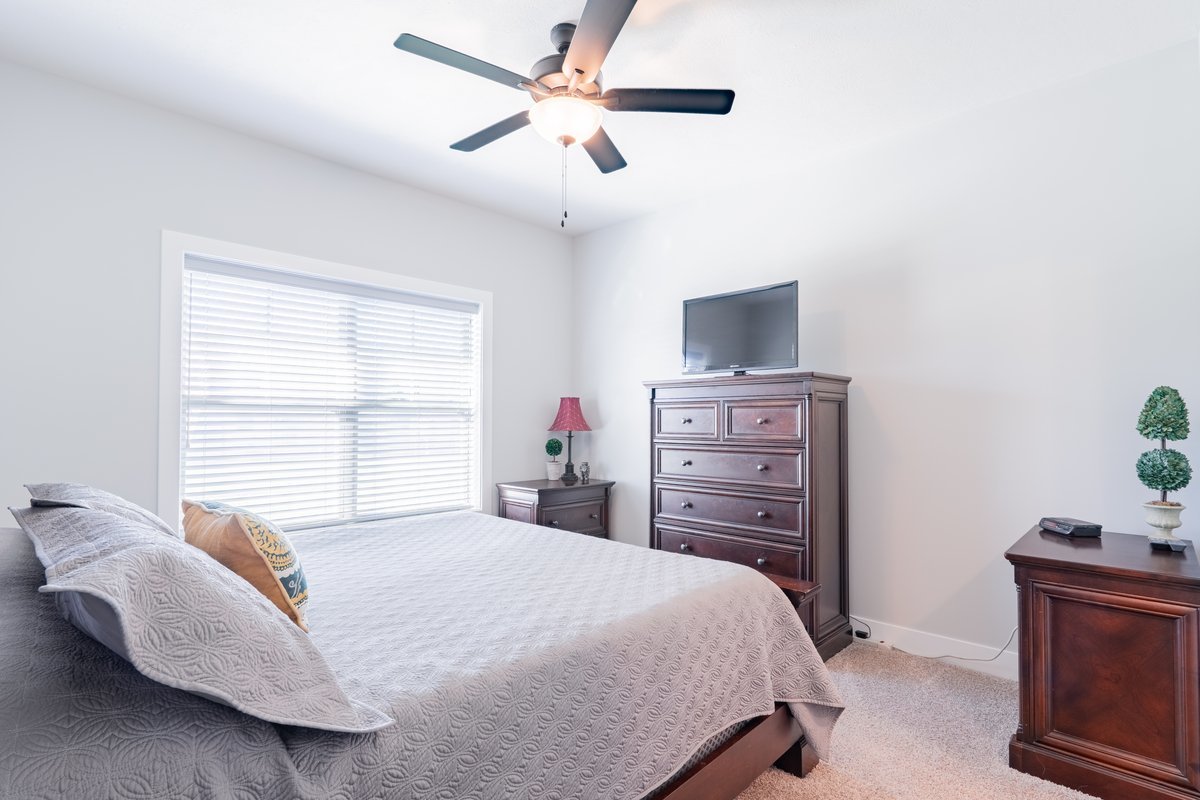 1809 Glenbridge Road Bloomington, IL 61704 - Photo 9 of 23 a bedroom with a bed and a flat screen tv