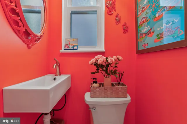 a bathroom with a sink mirror and toilet