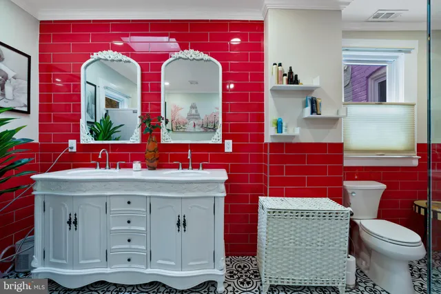 a bathroom with a toilet sink and mirror