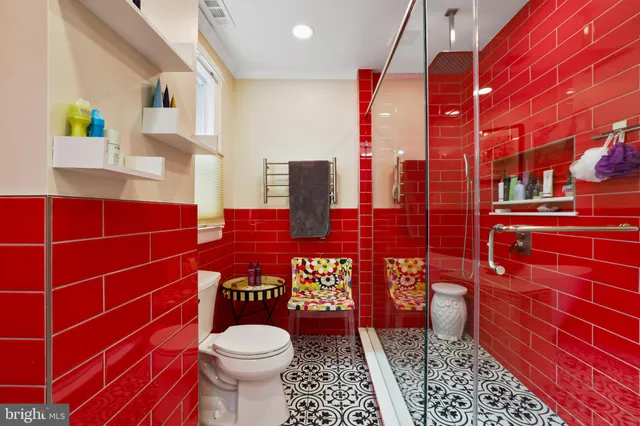 a bathroom with a toilet and a shower