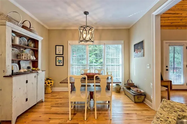 a view of a dining room with furniture wooden floor and chandelier