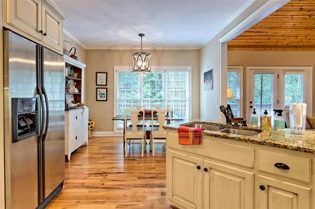 a kitchen with stainless steel appliances granite countertop a stove refrigerator and cabinets