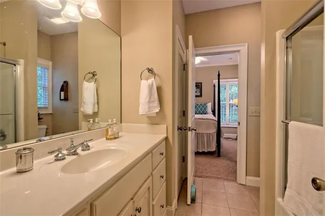 a en suite bathroom with a double vanity sink a mirror and shower
