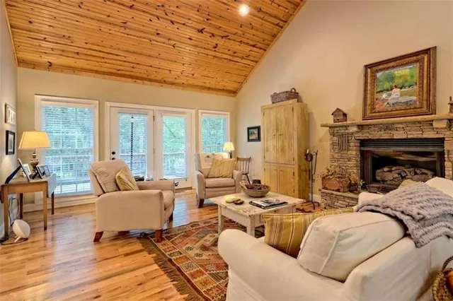 a living room with fireplace furniture and a large window